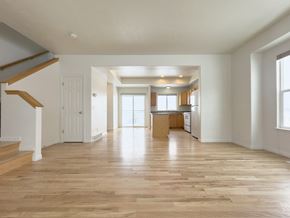 Draper apartment for rent - the living room and kitchen of an empty house with wood floors