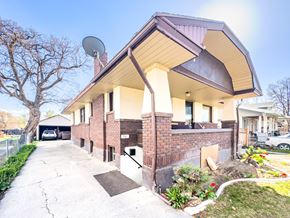 Provo apartment for rent - the front of a brick building with a satellite dish on the roof