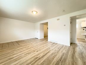 Springville apartment for rent - the living room and dining room of an apartment with wood flooring