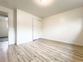 Springville apartment for rent - an empty living room with white walls and wood flooring