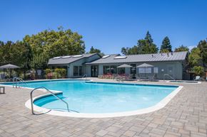 Hayward apartment for rent - A swimming pool with a building in the background.