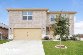 Fort Worth house for rent - A two-story house with a garage and a tree in the front yard.