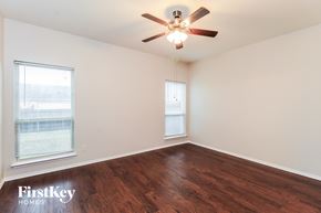 Royse City house for rent - a living room with wood floors and a ceiling fan