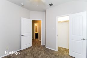 Royse City house for rent - a bedroom with two closets and two doors and a bathroom