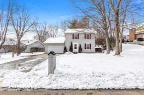 Monroe house for rent - a white house with red shuttered windows in the snow