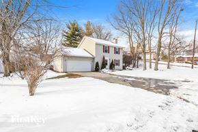 Monroe house for rent - a white house with a driveway in the snow