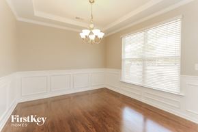 Huntersville house for rent - a dining room with wood floors and a window and a chandelier