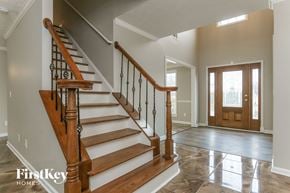 Lithonia house for rent - the foyer and entryway of a house with a staircase and a wooden door