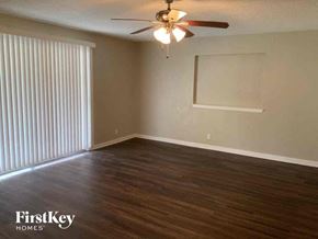 Fort Worth house for rent - an empty living room with wood flooring and a ceiling fan