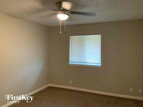 Fort Worth house for rent - a bedroom with a ceiling fan and a window