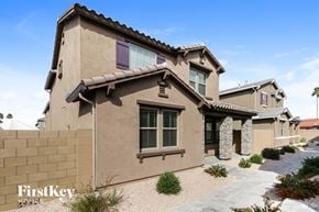 Mesa house for rent - a beige house with purple window shutters and a stone wall