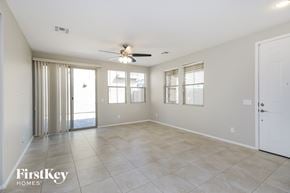 Mesa house for rent - a spacious living room with tile flooring and a ceiling fan
