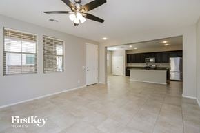 Mesa house for rent - an empty kitchen and living room with a ceiling fan