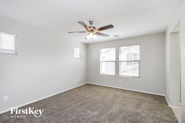 Mesa house for rent - the spacious living room with ceiling fan and carpet