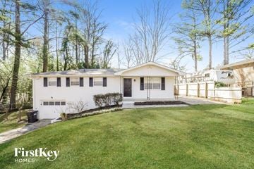Smyrna house for rent - a white house with a grassy yard and trees