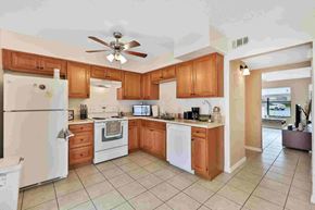 Port Orange apartment for rent - a large kitchen with white appliances and wooden cabinets
