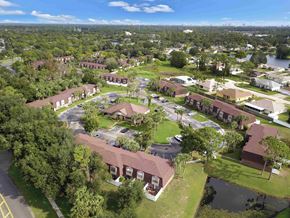 Port Orange apartment for rent - an aerial view of the campus with buildings and a body of water