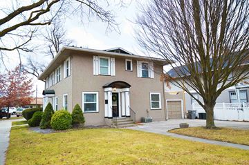 Boise house for rent - the front of a house with a lawn and a tree