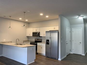 Penn Yan apartment for rent - a kitchen with stainless steel appliances and white cabinets