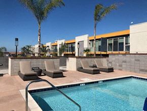National City apartment for rent - a swimming pool with lounge chairs next to a building