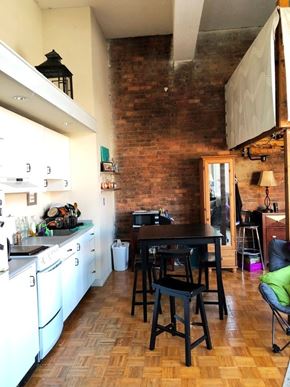 Boston apartment for rent - A kitchen with a wooden table and chairs.