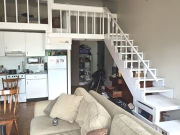 Boston apartment for rent - A living room with a couch and a staircase.