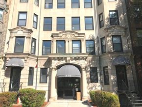 Boston apartment for rent - A building with a large front entrance and awnings on the windows.