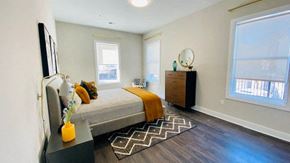 Elizabeth apartment for rent - a bedroom with a bed and two windows