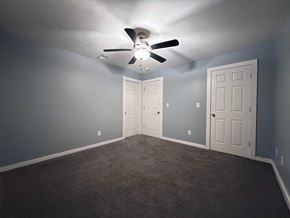 East Point apartment for rent - A room with a ceiling fan and two doors.