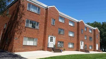Monroe Township apartment for rent - a brick apartment building with a sidewalk in front of it