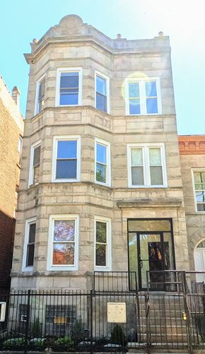 Chicago apartment for rent - a tall building with a fence in front of it