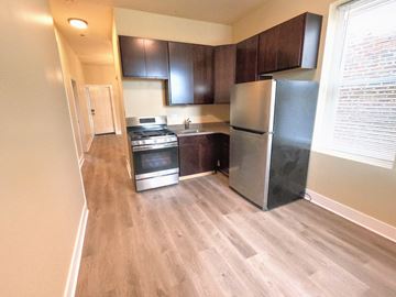 Chicago apartment for rent - a kitchen with stainless steel appliances and wooden floors