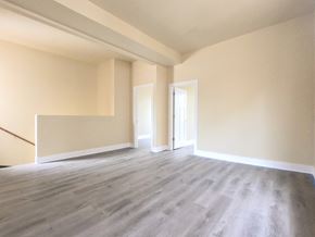 Chicago apartment for rent - an empty living room with white walls and wood floors