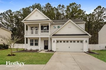 Moncks Corner house for rent - a white house with a white porch and a driveway