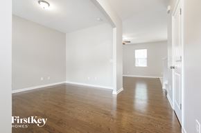 Moncks Corner house for rent - the living room and dining room with hardwood floors and white walls