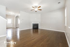 Moncks Corner house for rent - an empty living room with a ceiling fan and a fireplace