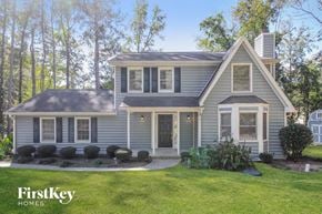 Lawrenceville house for rent - a blue house with a lawn and trees
