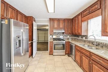 Lawrenceville house for rent - a large kitchen with wooden cabinets and stainless steel appliances