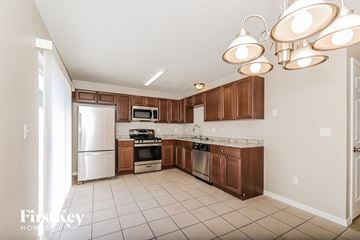 Davenport house for rent - a kitchen with wooden cabinets and stainless steel appliances