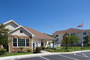 Andover apartment for rent - A small building with a flag on top is in front of a larger building.