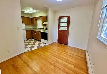 Charlottesville apartment for rent - A kitchen with wooden floors and a checkered floor in the middle.