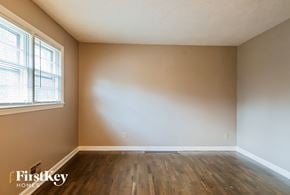 Powder Springs house for rent - A room with wooden floors and a window letting in natural light.