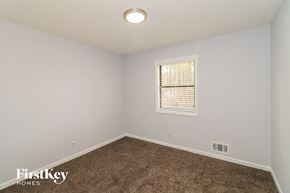 Woodstock house for rent - a bedroom with a carpeted floor and a window