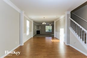 Gastonia house for rent - A spacious hallway with wooden floors and white walls.