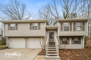 Douglasville house for rent - a beige and white house with stairs in front of it