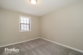 Douglasville house for rent - a bedroom with a carpeted floor and a window