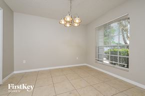 Lakeland house for rent - a dining room with a large window and a tiled floor
