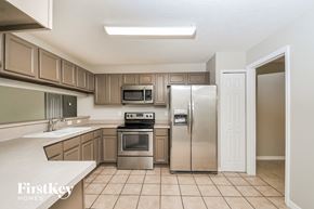 Lakeland house for rent - a kitchen with stainless steel appliances and wooden cabinets