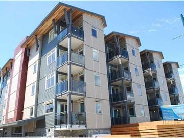 Delta apartment for rent - a building with a wooden fence in front of it