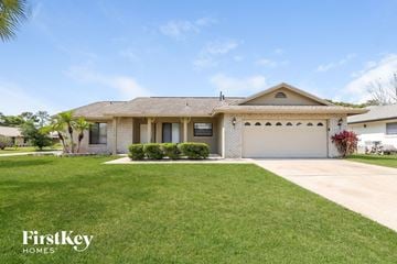 Orlando house for rent - a home with a lawn and a garage